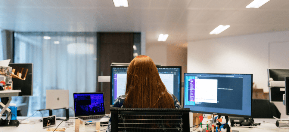Red headed woman working at her computer